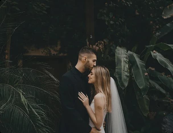 A couple sharing a forehead kiss